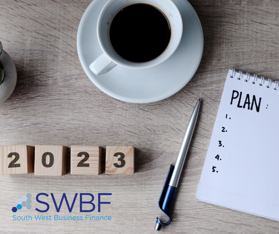 an image of a coffee cup, a notepad with a plan and 2023 calendar